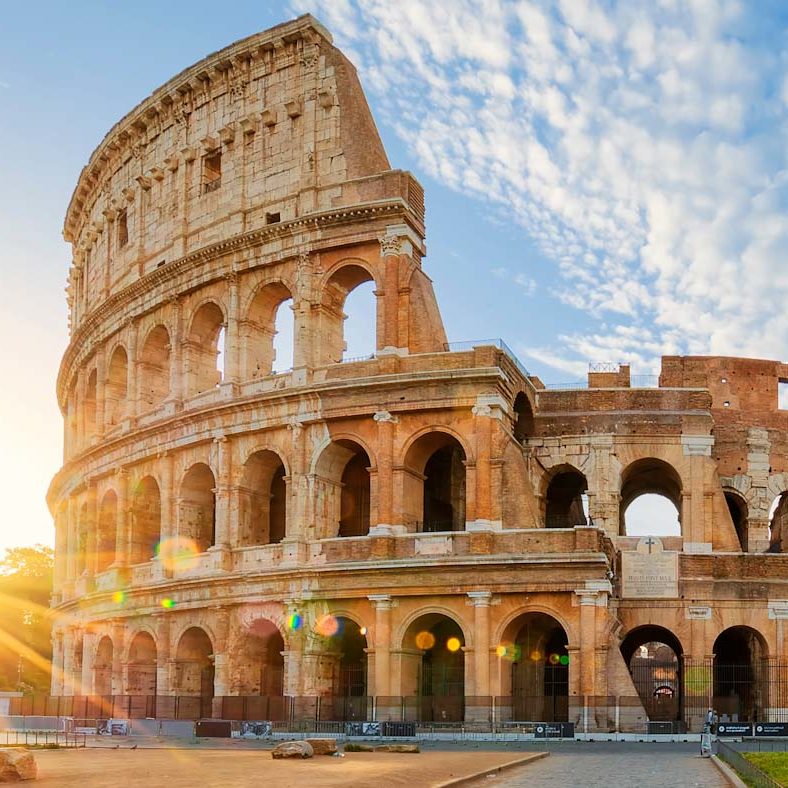 Panoramic view of Colosseum in Rome and morning sun, Italy, Europe.