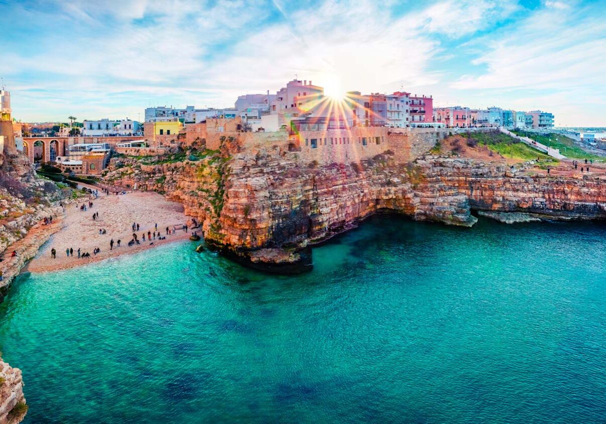 Panoramic spring cityscape of Polignano a Mare town, Puglia region, Italy, Europe. Marvelous evening view of Adriatic sea. Traveling concept background.